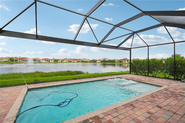 view of swimming pool featuring a water view, a patio, and glass enclosure