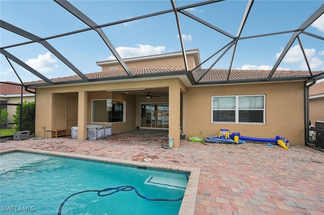 back of property featuring ceiling fan, a lanai, and a patio area