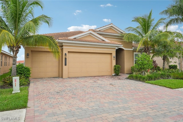 mediterranean / spanish house with a garage