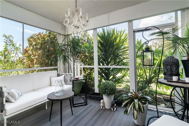 sunroom featuring an inviting chandelier and a healthy amount of sunlight