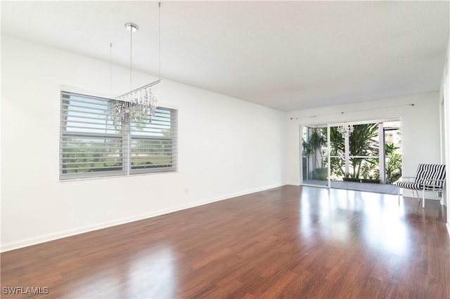interior space with wood finished floors and baseboards