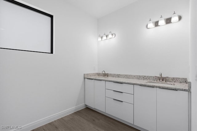 bathroom with vanity and hardwood / wood-style floors