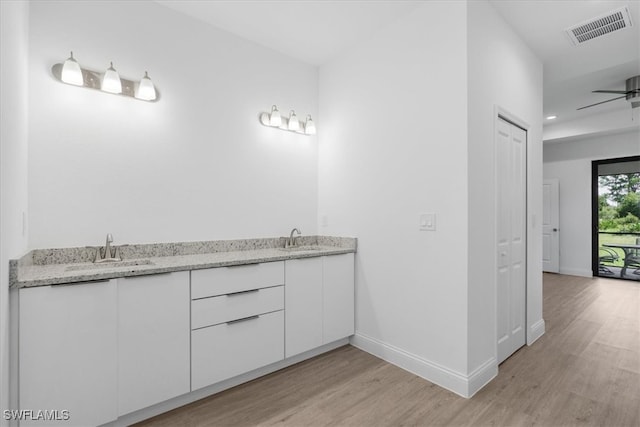 bathroom with vanity, ceiling fan, and hardwood / wood-style flooring