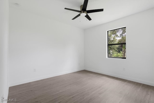 spare room with ceiling fan and hardwood / wood-style flooring