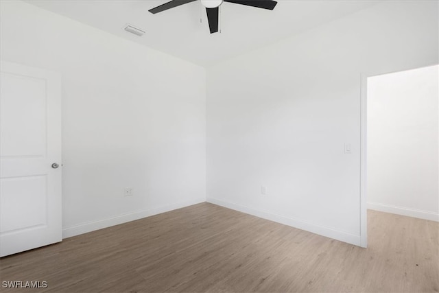 empty room with ceiling fan and light hardwood / wood-style flooring