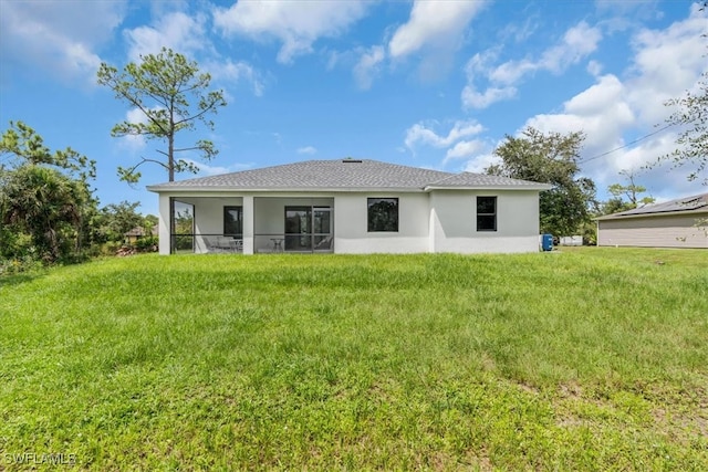 rear view of house with a lawn