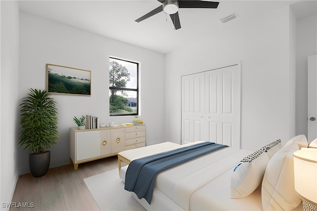 bedroom featuring ceiling fan, a closet, and light hardwood / wood-style floors