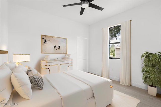 bedroom with light hardwood / wood-style flooring and ceiling fan