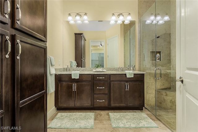 bathroom with tile patterned floors, ceiling fan, vanity, and an enclosed shower