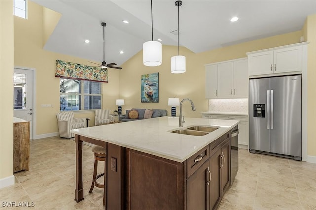 kitchen with ceiling fan, sink, pendant lighting, white cabinets, and appliances with stainless steel finishes