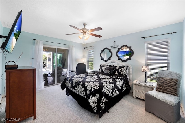 bedroom with access to exterior, a ceiling fan, and carpet