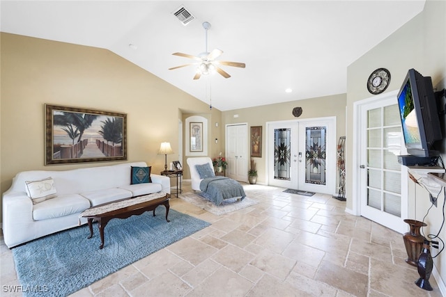 living area featuring visible vents, a ceiling fan, vaulted ceiling, stone tile floors, and french doors