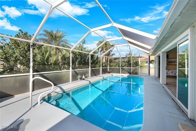 view of swimming pool featuring a lanai