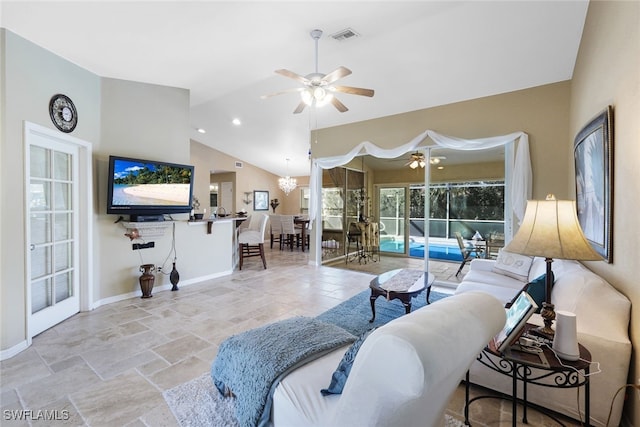 living room with ceiling fan with notable chandelier and high vaulted ceiling