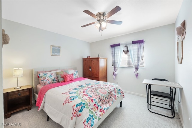 bedroom with light colored carpet, ceiling fan, and baseboards