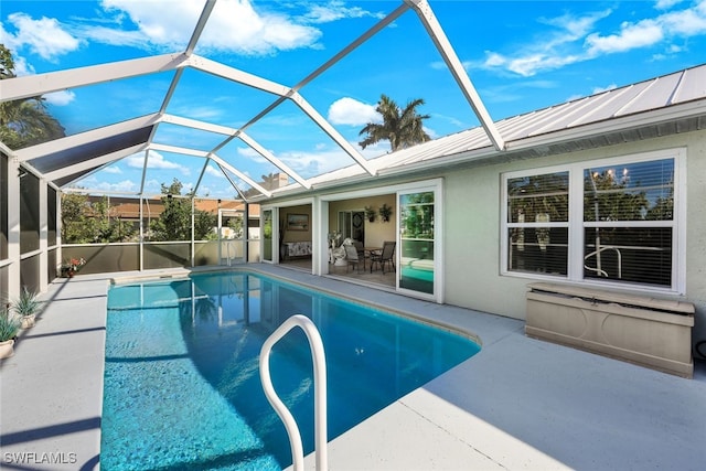 pool with glass enclosure and a patio