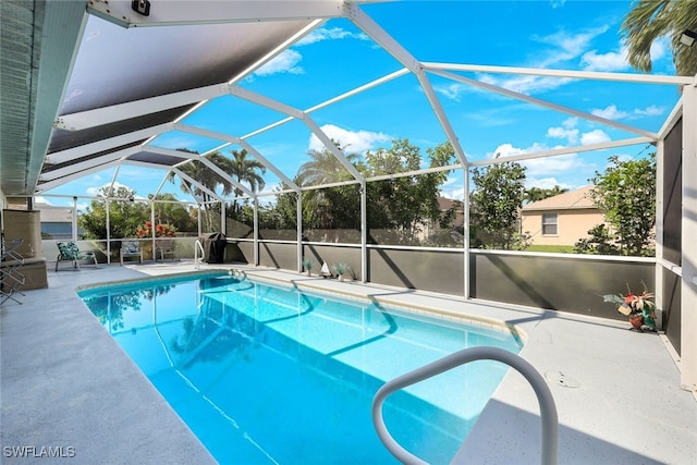 view of swimming pool featuring a lanai and a patio area