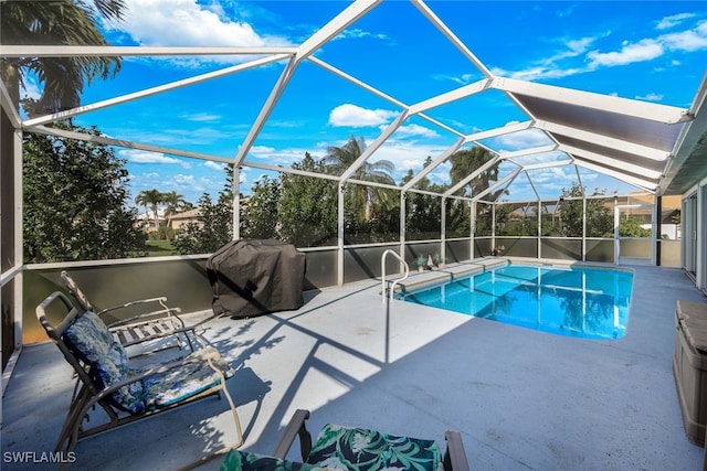 view of swimming pool featuring a lanai and a patio area