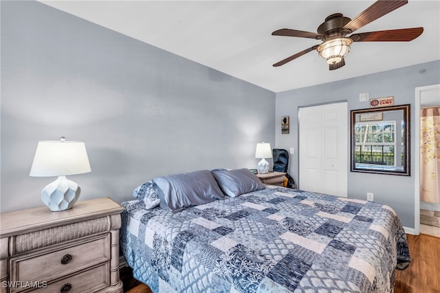 bedroom featuring a closet, ensuite bath, hardwood / wood-style flooring, and ceiling fan