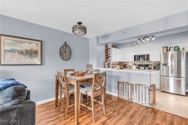 dining area with light hardwood / wood-style floors