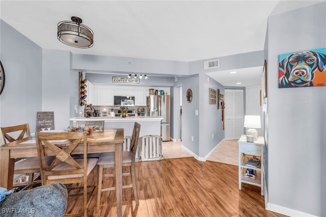 dining area featuring light wood-type flooring