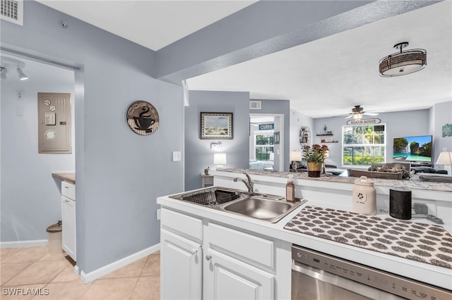 kitchen with ceiling fan, stainless steel dishwasher, white cabinets, sink, and light tile patterned flooring