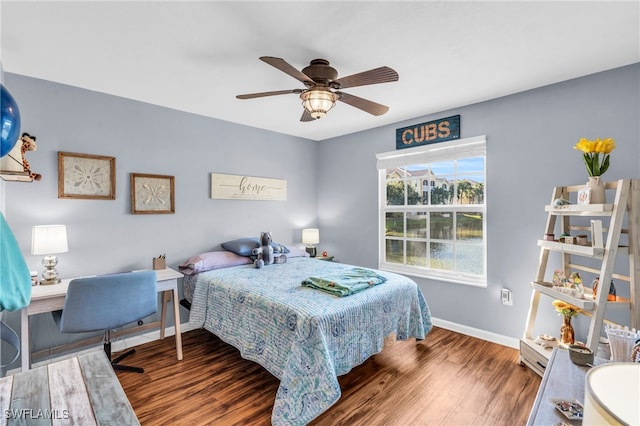 bedroom with ceiling fan and dark wood-type flooring