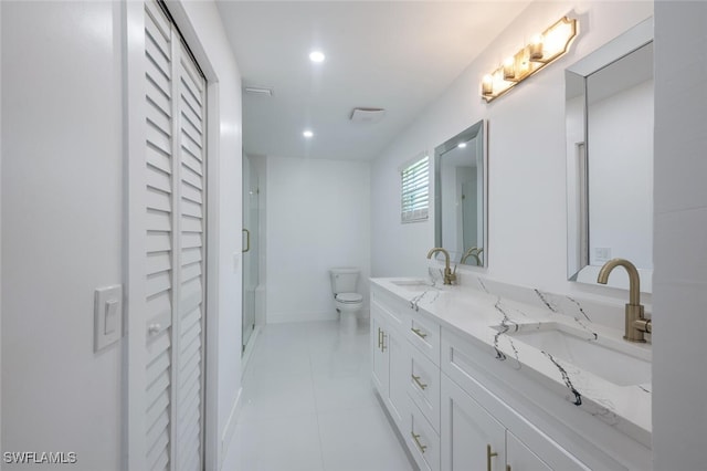 bathroom featuring tile patterned floors, vanity, an enclosed shower, and toilet