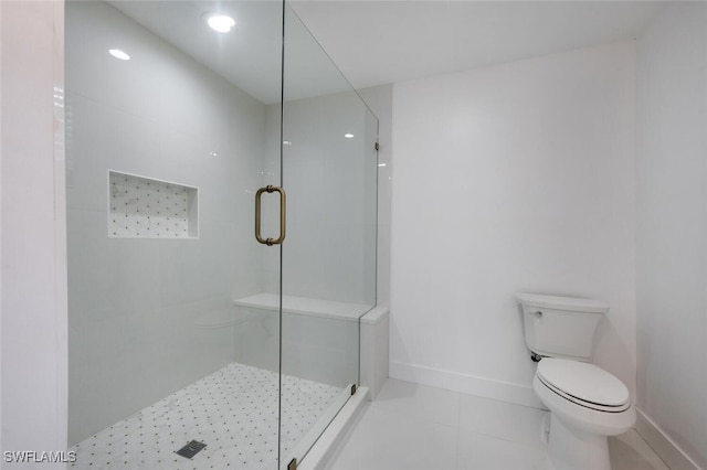 bathroom featuring tile patterned floors, toilet, and an enclosed shower