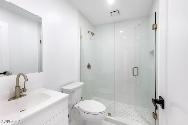 bathroom featuring vanity, toilet, and an enclosed shower