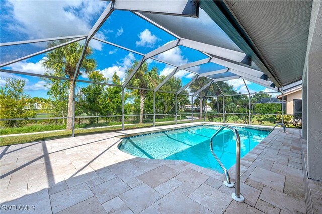 view of swimming pool with a lanai and a patio area