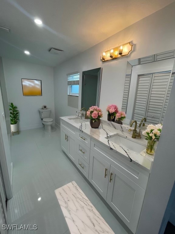 bathroom with tile patterned floors, vanity, and toilet