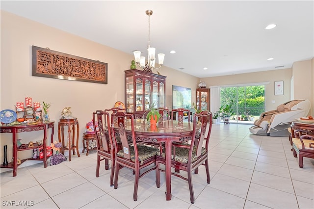 dining room with light tile patterned flooring and a chandelier