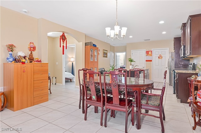 tiled dining space with a chandelier