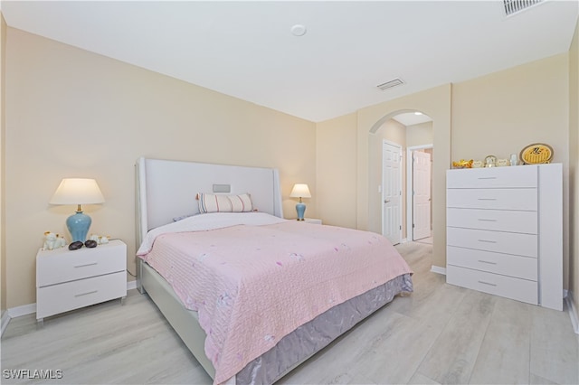 bedroom with light hardwood / wood-style flooring and a closet