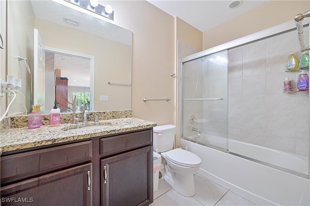 full bathroom featuring tile patterned floors, combined bath / shower with glass door, vanity, and toilet