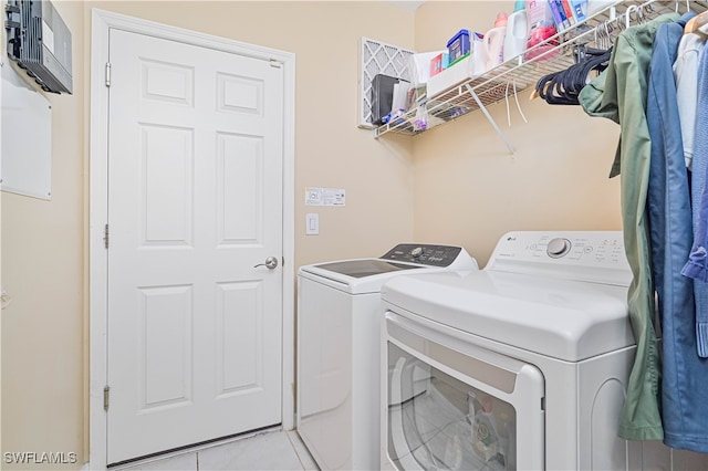 washroom featuring light tile patterned flooring and separate washer and dryer