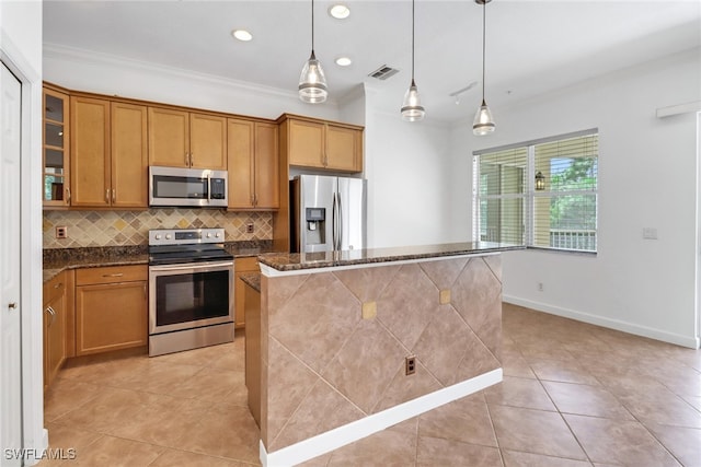 kitchen with a center island, appliances with stainless steel finishes, decorative light fixtures, ornamental molding, and dark stone countertops