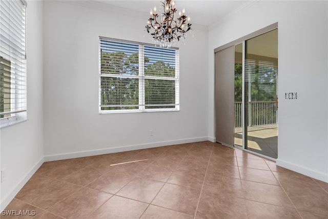 empty room with an inviting chandelier, crown molding, and light tile patterned floors