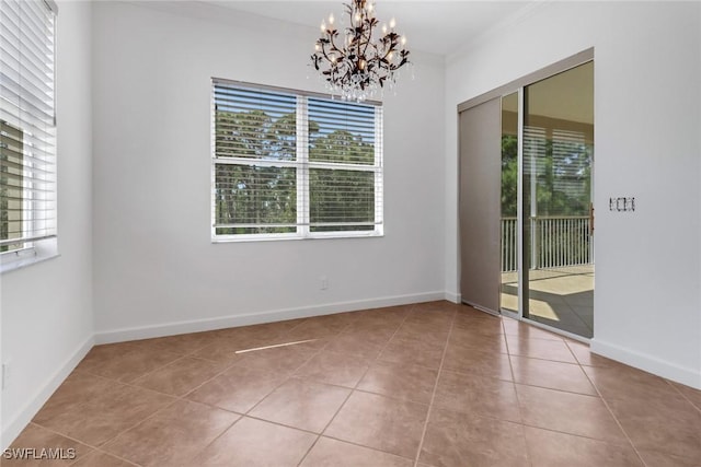 tiled spare room with an inviting chandelier, baseboards, and a wealth of natural light