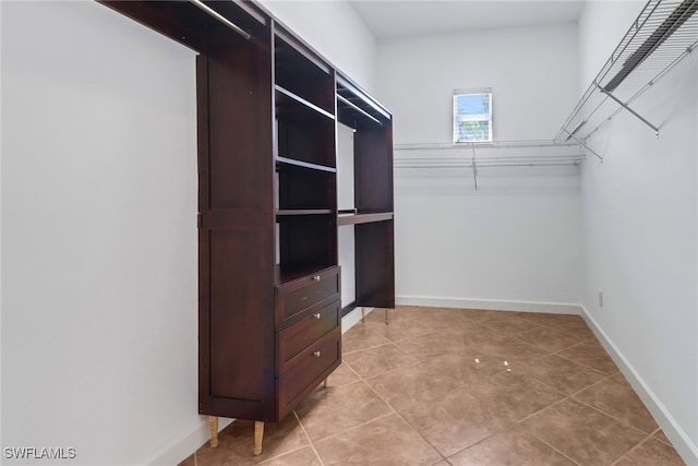 spacious closet with light tile patterned floors