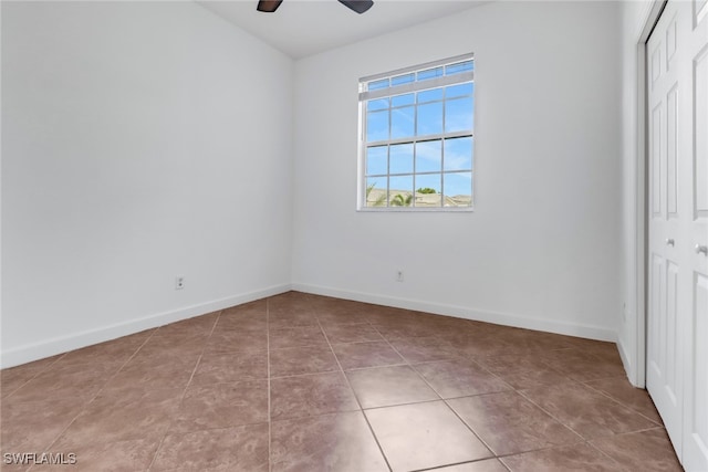 unfurnished bedroom featuring light tile patterned flooring, ceiling fan, and a closet