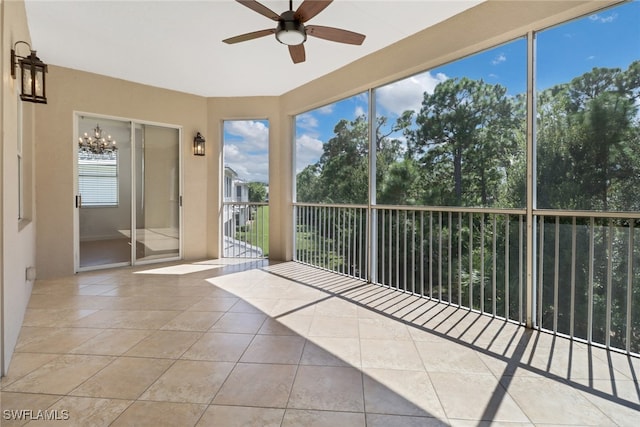 unfurnished sunroom featuring ceiling fan