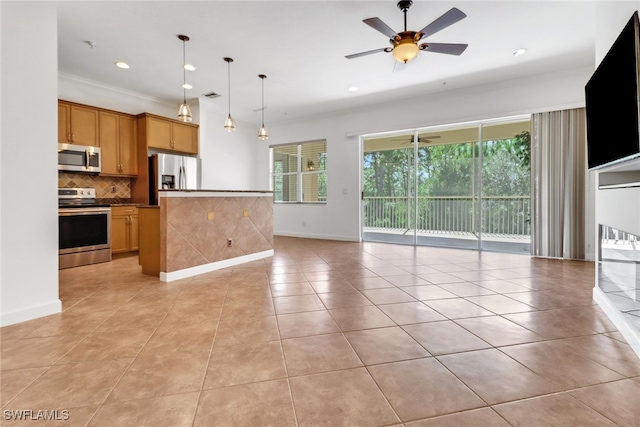 kitchen with ceiling fan, pendant lighting, backsplash, appliances with stainless steel finishes, and crown molding