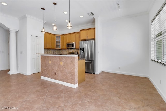 kitchen featuring pendant lighting, decorative columns, a kitchen island, stainless steel appliances, and ornamental molding