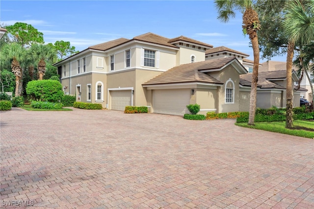 mediterranean / spanish-style home with a garage