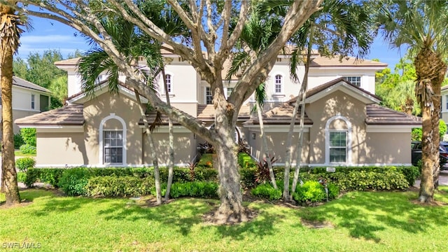 mediterranean / spanish house with a front lawn