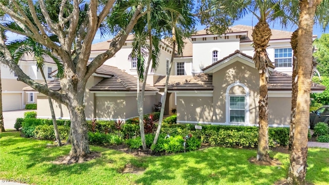 view of front of property featuring a garage and a front lawn