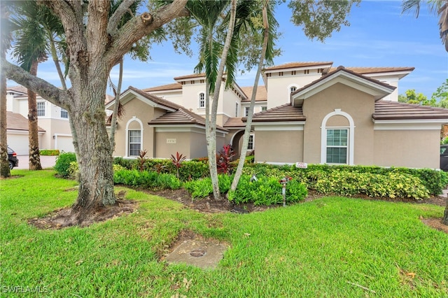 mediterranean / spanish home with a front yard