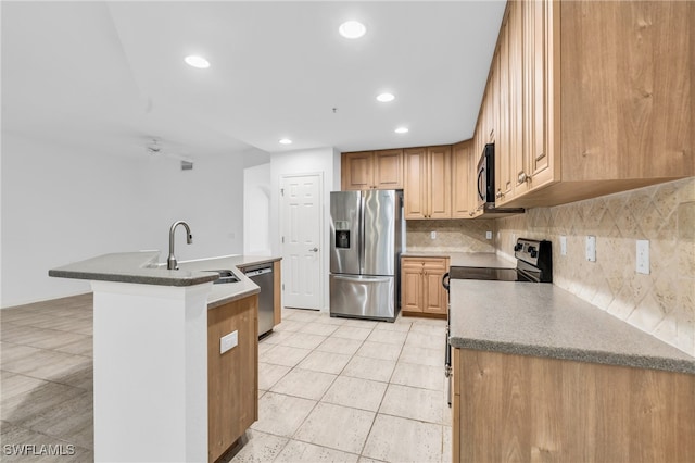 kitchen with light tile patterned floors, appliances with stainless steel finishes, backsplash, and sink